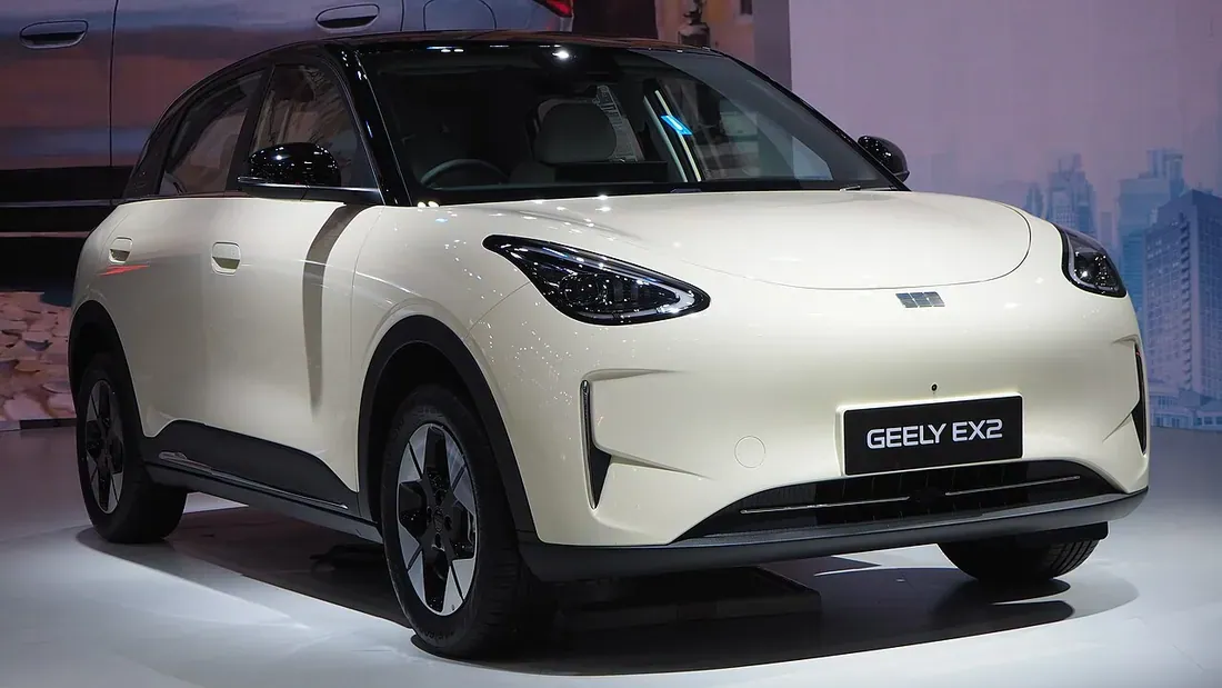 Cream Geely EX2 small electric car on a motor-show stand