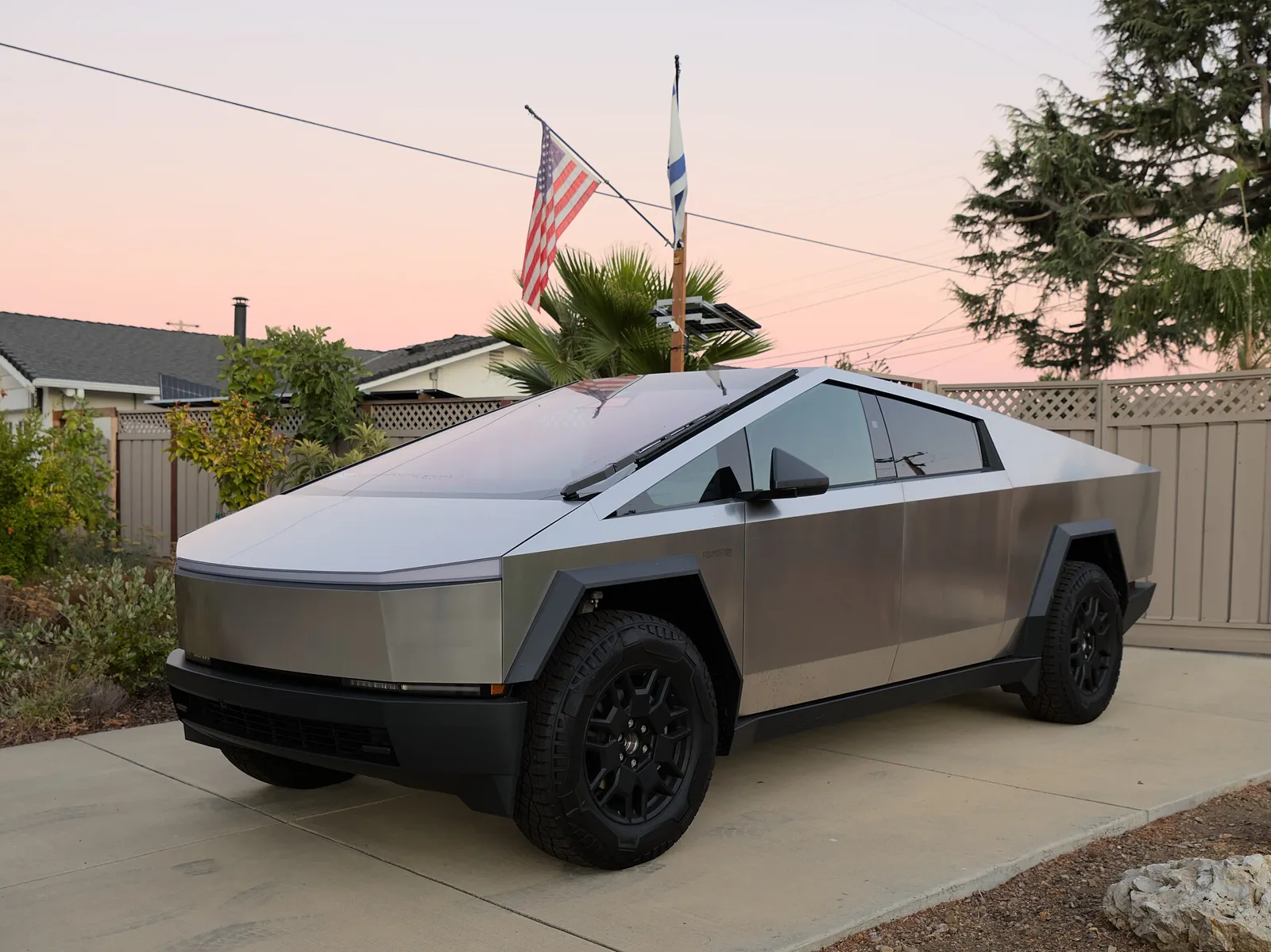 Stainless-steel Tesla Cybertruck Foundation Series parked at dusk