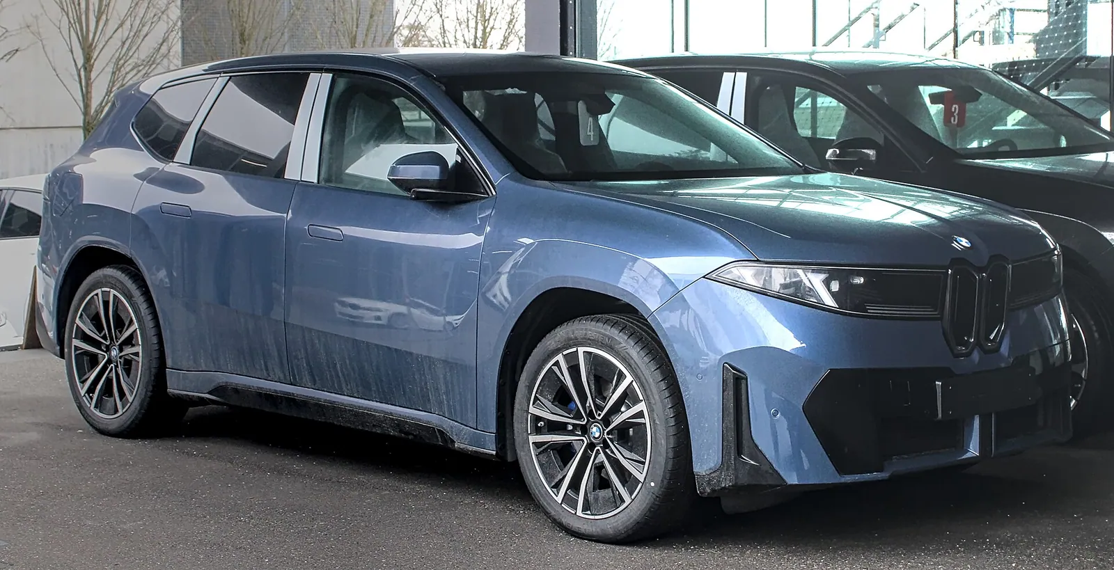 Blue BMW iX3 (new Neue Klasse generation), front three-quarter view