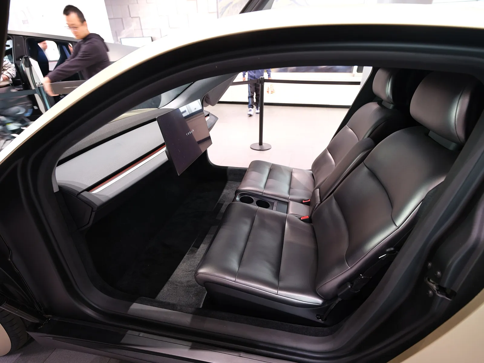 Two-seat Tesla Cybercab cabin with a large central screen and no steering wheel or pedals