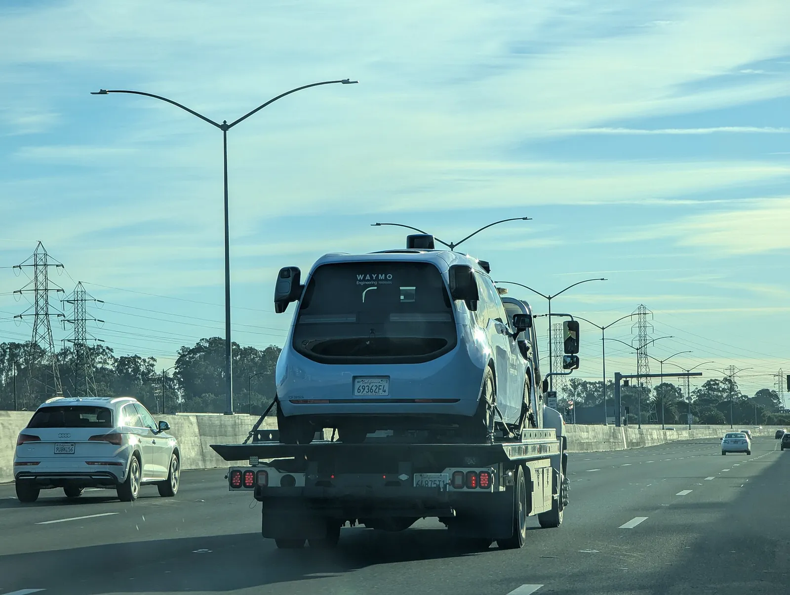 Waymo Ojai minivan robotaxi driving on a US highway