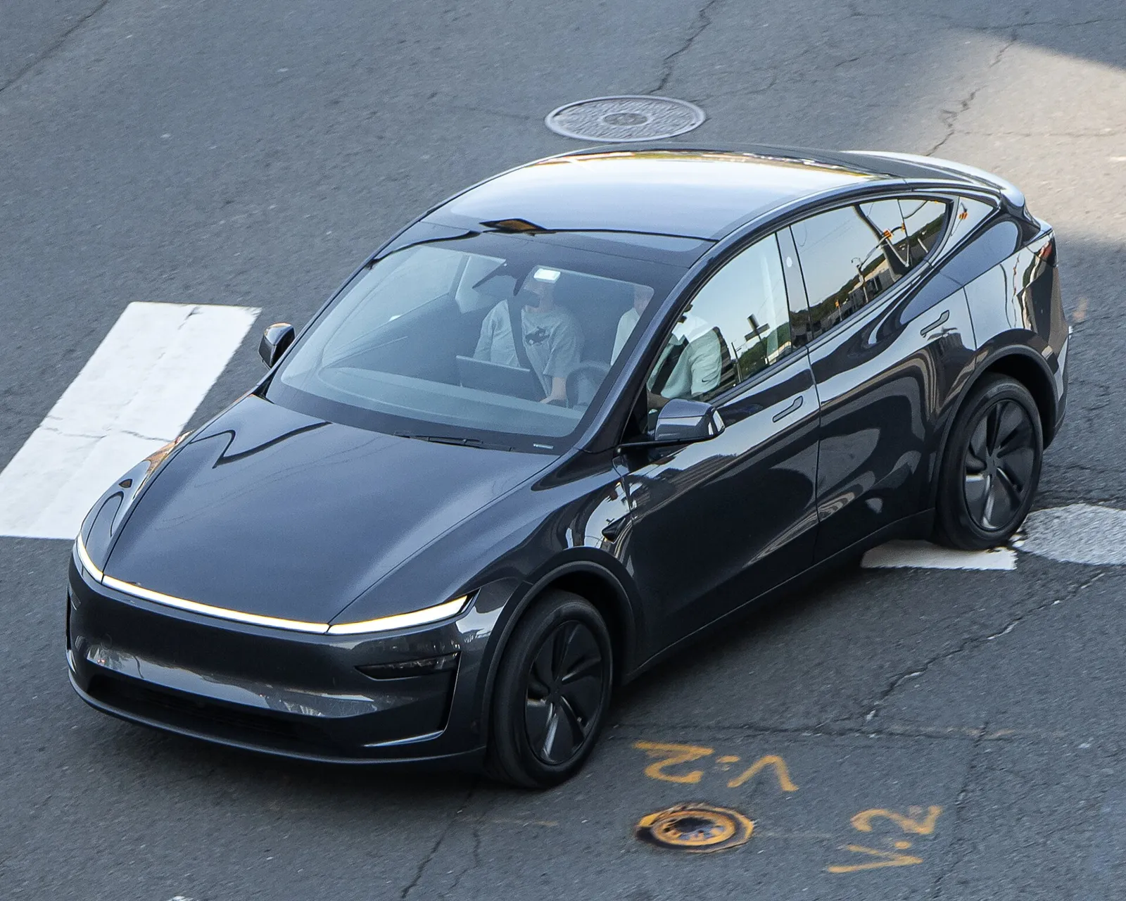 Black Tesla Model Y (current generation), front three-quarter view