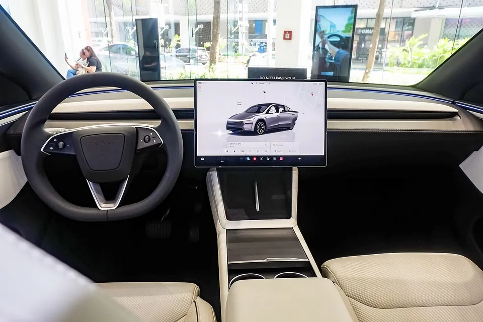 Tesla Model Y L Premium Long Range AWD cabin showing the front seats, the centre screen and the second-row captain's chairs